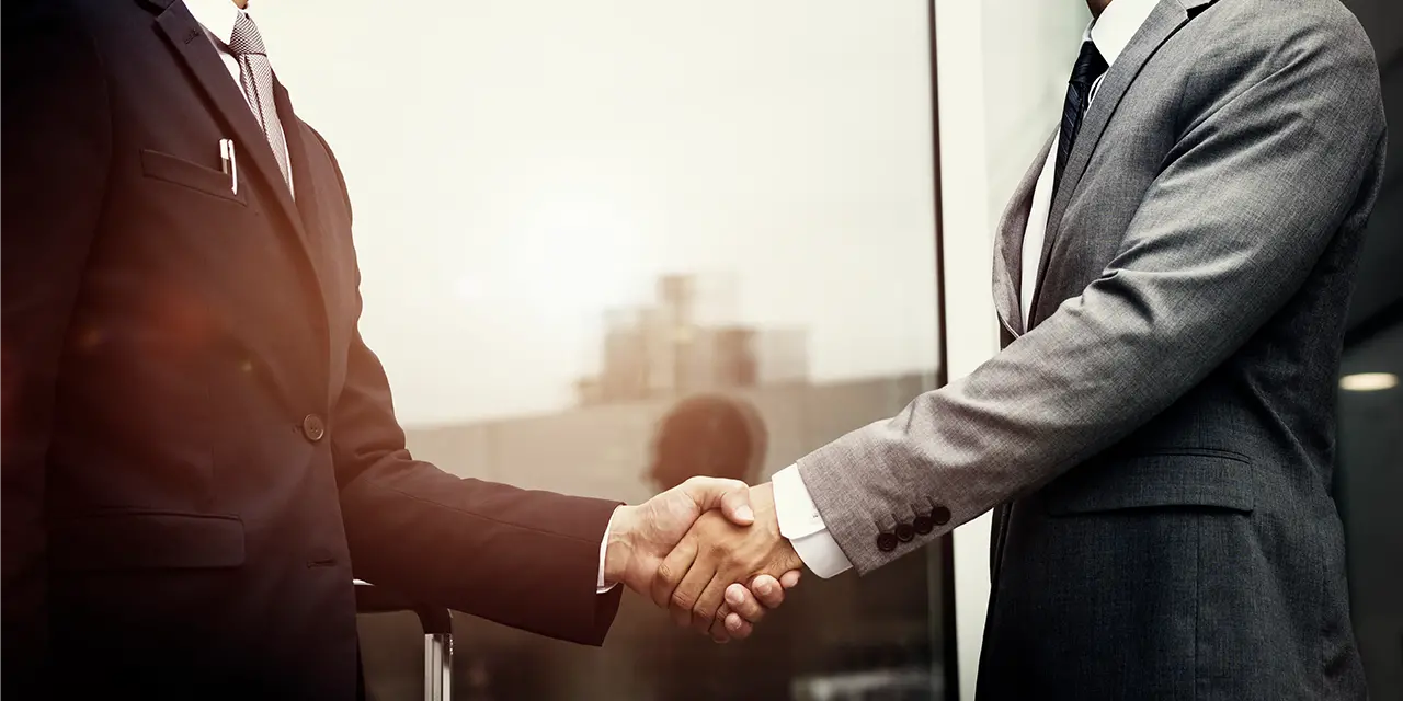 Professionals making connections after sharing contact via business card