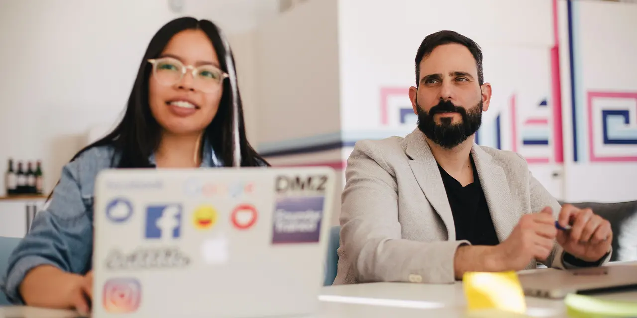 Two professionals listening to talks by experts in their field at networking events