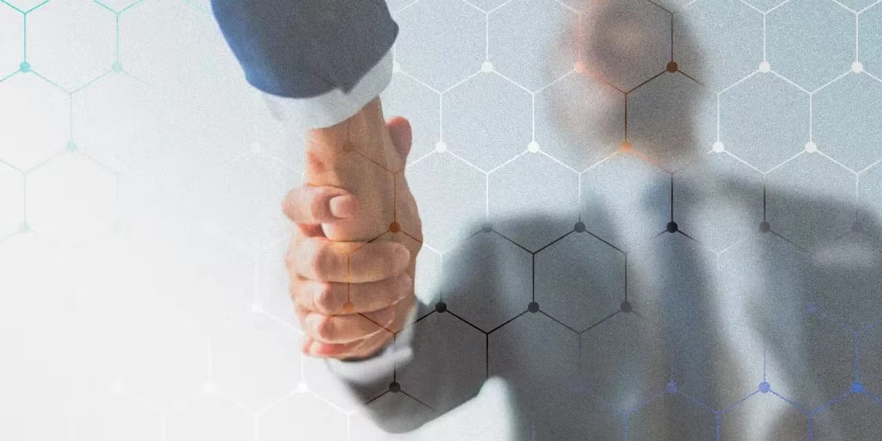 Business partners shaking hands after receiving digital business card
